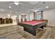 Spacious basement rec room with a pool table, bar area, and hardwood floors at 104 Hidden Springs Ln, Peachtree City, GA 30269