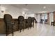Finished basement boasts a stylish bar area with seating and tile flooring at 104 Hidden Springs Ln, Peachtree City, GA 30269