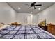 Finished basement bedroom featuring a comfortable bed, ceiling fan, and entertainment center at 104 Hidden Springs Ln, Peachtree City, GA 30269
