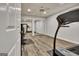 Basement home gym with hardwood floors, mirrored closets, and a treadmill at 104 Hidden Springs Ln, Peachtree City, GA 30269