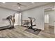 Basement home gym with hardwood floors, exercise equipment, and a ceiling fan at 104 Hidden Springs Ln, Peachtree City, GA 30269
