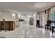 Spacious basement with a chandelier, tiled floors, and a full kitchen area at 104 Hidden Springs Ln, Peachtree City, GA 30269