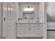 Bathroom vanity with white cabinets, countertop, a mirror, and modern lighting offering both style and functionality at 104 Hidden Springs Ln, Peachtree City, GA 30269
