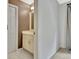 Bathroom with a light brown accent wall, tiled floors, and vanity at 104 Hidden Springs Ln, Peachtree City, GA 30269