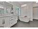 Spa-like bathroom featuring a freestanding tub, double vanity, and elegant fixtures for a luxurious experience at 104 Hidden Springs Ln, Peachtree City, GA 30269