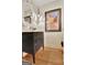 Stylish bathroom with a decorative mirror, elegant vanity, and hardwood floors, creating a sophisticated and inviting space at 104 Hidden Springs Ln, Peachtree City, GA 30269