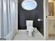 Well-lit toilet area featuring an oval window providing ample natural light in the bathroom at 104 Hidden Springs Ln, Peachtree City, GA 30269