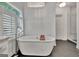 Modern bathroom with a freestanding tub, plantation shutters, and a glass-enclosed shower for a relaxing retreat at 104 Hidden Springs Ln, Peachtree City, GA 30269