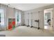 Spacious bedroom with large windows, and a clothing rack, providing a bright and functional space at 104 Hidden Springs Ln, Peachtree City, GA 30269