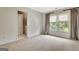 Carpeted bedroom with natural light and an en suite bathroom at 104 Hidden Springs Ln, Peachtree City, GA 30269