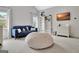 Cozy bedroom with a blue loveseat, beanbag, and decorative elements, creating a comfortable and inviting space at 104 Hidden Springs Ln, Peachtree City, GA 30269