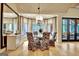 Bright dining room with a glass table, floral chairs, and a bay window at 104 Hidden Springs Ln, Peachtree City, GA 30269