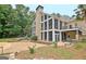 A large backyard features an outdoor fireplace and grilling area. A spacious patio complements the outdoor kitchen at 104 Hidden Springs Ln, Peachtree City, GA 30269