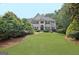 Charming home with a well-manicured lawn, mature trees, and inviting curb appeal at 104 Hidden Springs Ln, Peachtree City, GA 30269