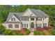 A stately home with meticulously manicured landscaping, a stone walkway, and a well-maintained lawn at 104 Hidden Springs Ln, Peachtree City, GA 30269