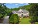 Stately home with a meticulously manicured lawn and lush landscaping creating an inviting curb appeal at 104 Hidden Springs Ln, Peachtree City, GA 30269