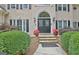 Charming front entrance with double doors, stone steps, and manicured greenery at 104 Hidden Springs Ln, Peachtree City, GA 30269