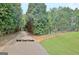 A paved golf cart path, lined with trees, leads to a private golf course, offering recreation and convenience at 104 Hidden Springs Ln, Peachtree City, GA 30269