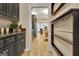 Hallway view looking into kitchen with dark cabinets and marble countertops at 104 Hidden Springs Ln, Peachtree City, GA 30269