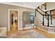 Hallway with hardwood floors, stairs, and decorative mirror-accented furniture at 104 Hidden Springs Ln, Peachtree City, GA 30269