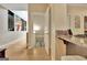 Hallway with hardwood floors that leads to the basement, and a small art piece on the wall at 104 Hidden Springs Ln, Peachtree City, GA 30269