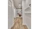 Hallway with hardwood floors, white walls, and recessed lighting, featuring built-in shelves at 104 Hidden Springs Ln, Peachtree City, GA 30269