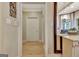 Hallway looking into living room featuring a chandelier, bay windows, and floral chairs at 104 Hidden Springs Ln, Peachtree City, GA 30269