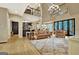 Bright living room features a chandelier, open staircase, and adjoined kitchen at 104 Hidden Springs Ln, Peachtree City, GA 30269