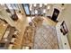Overhead shot of a cozy living room showcasing a large chandelier, hardwood floors, and a patterned rug at 104 Hidden Springs Ln, Peachtree City, GA 30269