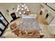 Spacious living room featuring a fireplace, a large chandelier, and hardwood floors at 104 Hidden Springs Ln, Peachtree City, GA 30269