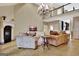 Elegant living room features a fireplace, chandelier, and comfortable seating area at 104 Hidden Springs Ln, Peachtree City, GA 30269
