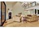 Spacious living room with a fireplace, hardwood floors, and a stunning chandelier at 104 Hidden Springs Ln, Peachtree City, GA 30269