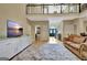 Spacious living room showcasing an entryway and large area rug at 104 Hidden Springs Ln, Peachtree City, GA 30269