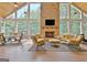 Bright sunroom features a stone fireplace, vaulted ceilings, and expansive windows at 104 Hidden Springs Ln, Peachtree City, GA 30269