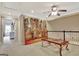 Loft area with artwork, unique glass table, and view of the hallway adds a cozy touch to the upper level at 104 Hidden Springs Ln, Peachtree City, GA 30269