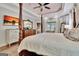 Luxurious main bedroom featuring a four-poster bed, tray ceiling, and abundant natural light for a serene retreat at 104 Hidden Springs Ln, Peachtree City, GA 30269