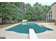 Beautiful backyard pool and sundeck area, surrounded by mature trees and a privacy fence at 104 Hidden Springs Ln, Peachtree City, GA 30269
