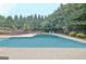 Inviting outdoor pool surrounded by lush landscaping and mature trees at 104 Hidden Springs Ln, Peachtree City, GA 30269