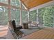 Outdoor seating area features unique hanging chairs and a modern fire pit at 104 Hidden Springs Ln, Peachtree City, GA 30269