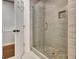 Modern glass enclosed shower with mosaic tile accents and stylish fixtures at 104 Hidden Springs Ln, Peachtree City, GA 30269