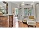 Cozy sitting area with a comfortable sofa, ottoman, and view to an outdoor deck, perfect for relaxing at 104 Hidden Springs Ln, Peachtree City, GA 30269