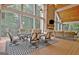 Comfortable seating arrangements in a screened sunroom, with large windows and natural light at 104 Hidden Springs Ln, Peachtree City, GA 30269