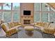 Bright sunroom features a stone fireplace, vaulted ceilings, and expansive windows at 104 Hidden Springs Ln, Peachtree City, GA 30269