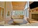 Bright sunroom features a stone fireplace, vaulted ceilings, and expansive windows at 104 Hidden Springs Ln, Peachtree City, GA 30269