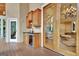 Wet bar on a screened porch with convenient cabinet and refrigerator at 104 Hidden Springs Ln, Peachtree City, GA 30269