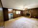 Warm living room with dark wood paneled walls and a stone fireplace at 1753 Brenda Dr, Jonesboro, GA 30236