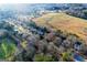 Expansive aerial view of a neighborhood surrounded by fields and trees on a sunny day at 402 Stonebrooke Dr, Auburn, GA 30011