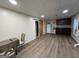 Spacious basement area features vinyl floors, drop ceiling, and a kitchenette with dark wood cabinets at 402 Stonebrooke Dr, Auburn, GA 30011