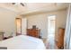 Bedroom leading to a bathroom and featuring a dresser, closet door and wood floors at 402 Stonebrooke Dr, Auburn, GA 30011