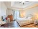Bright bedroom with wood floors, a tray ceiling, and a large window for natural light at 402 Stonebrooke Dr, Auburn, GA 30011